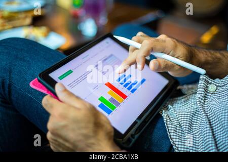 Asian business men using a tablet for working at coffee shop Stock Photo