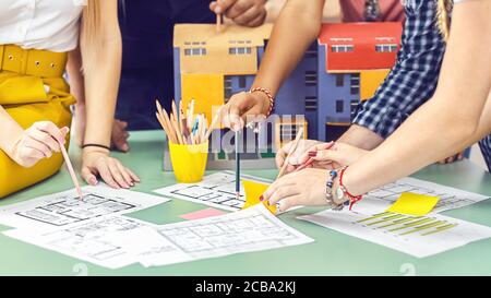 Creative architects team working on blueprint during brainstorm meeting Stock Photo