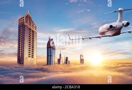 Private jet plane flying above Dubai city in beautiful sunset light. Modern and fastest mode of transportation, business life. Stock Photo