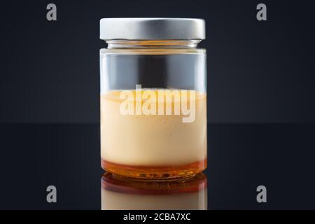 Cream caramel in a jar isolated on black background Stock Photo