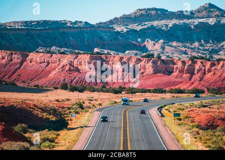 Asphalt highway and hill landscape under the blue sky. Curved Arizona Desert Road. Stock Photo