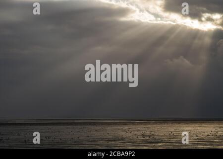 sun beams shining through the clouds over the North Sea, Netherlands, Schiermonnikoog Stock Photo