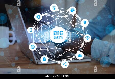 Big data analytics and business intelligence concept with businessman using laptop and mobile phone at office Stock Photo