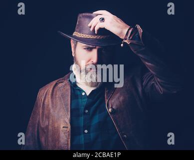 Handsome man in cowboy costume stay in dark. Vampire Hunter. Stock Photo