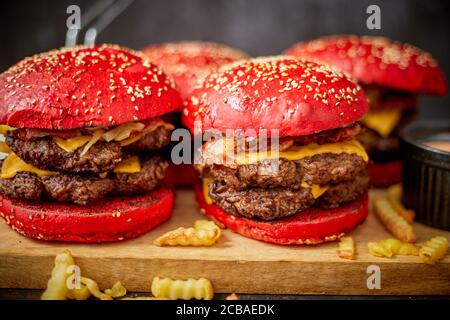 Burgers and french fries on board Stock Photo