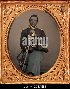 Union Cavalry Officer Displaying Sword, Holding Hat, Seated in Studio, 1861-65. Stock Photo