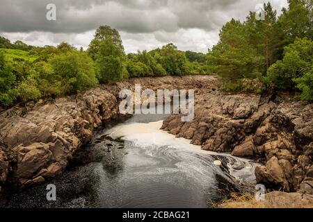 Water of Ken river flowing through a rocky gorge in Galloway, Scotland, due to Earlstoun Dam and Loch / reservoir being drained, on the Galloway Hydro Stock Photo