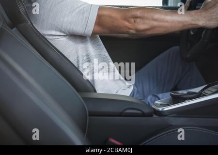 Ergonomics Inside Modern Vehicle. Caucasian Men in His 40s Driving His Premium Car. Driver Body Position Behind Car Steering Wheel. Automotive and Tra Stock Photo