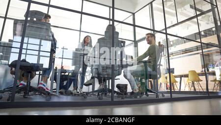 Brainstorming. Group of multiracial business people working together, discussing project while sitting in a conference room, having a meeting in the Stock Photo