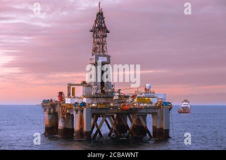 NORTH SEA, NORWAY - 2015 MAY. Beautiful sunset at offshore at oil rig Transocean Prospect and offshore vessel KL Sandefjord in North Sea. Stock Photo