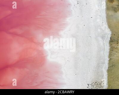 Top view of the shore covered with salt and pink lake. Stock Photo