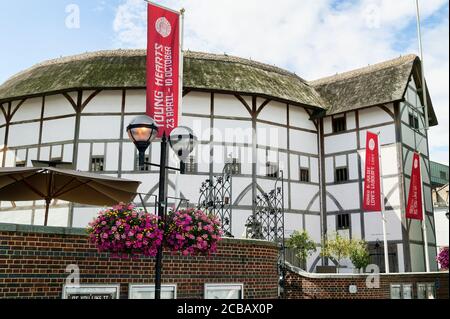 London, UK – July 30, 2009 : The  Globe Theatre advertising tours and exhibitions with banners which is a popular travel destination tourist attractio Stock Photo