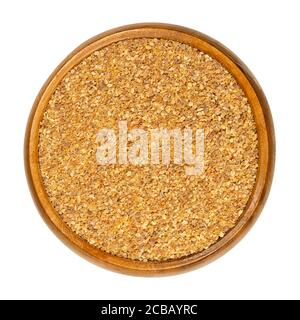 Dried grated lemon peel in a wooden bowl. Dry zests of ripe yellow edible citrus fruits. Citrus limon. Used as flavoring for baking and cooking. Stock Photo