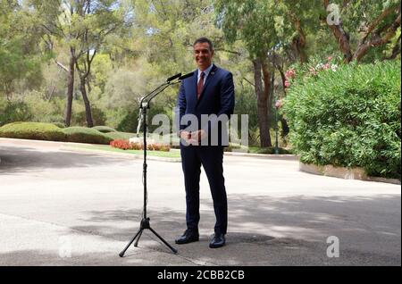 12 August 2020, Spain, Palma: Pedro Sanchez, Prime Minister of Spain, smiles during a press conference after his meeting with King Felipe VI at the Palacio de Marivent in Palma de Mallorca. This was Sanchez's first public appearance with the monarch after the announcement that the former king Juan Carlos, suspected of corruption, has left Spain. Photo: Clara Margais/dpa Stock Photo