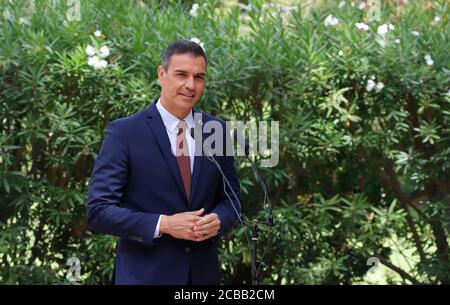 12 August 2020, Spain, Palma: Pedro Sanchez, Prime Minister of Spain, speaks at a press conference after his meeting with King Felipe VI at the Palacio de Marivent in Palma de Mallorca. This was Sanchez's first public appearance with the monarch after the announcement that the former king Juan Carlos, who is suspected of corruption, has left Spain. Photo: Clara Margais/dpa Stock Photo