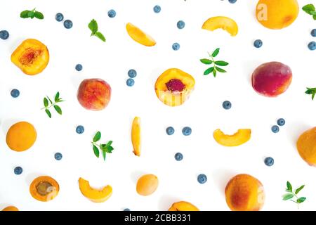 Peaches with blueberry and mint isolated on white. Summer fruits. Top view. Flat lay Stock Photo