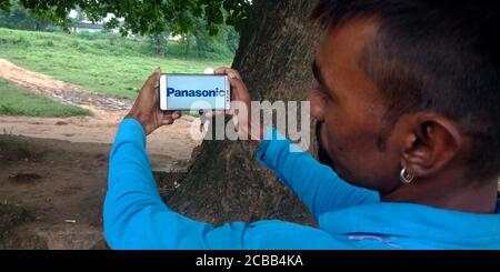 DISTRICT KATNI, INDIA - SEPTEMBER 18, 2019: Panasonic logo displayed on smart phone screen by indian village man hand holding mobile concept. Stock Photo