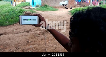 DISTRICT KATNI, INDIA - SEPTEMBER 18, 2019: Amazon Video logo displayed on smart phone screen by indian village man hand holding mobile concept. Stock Photo