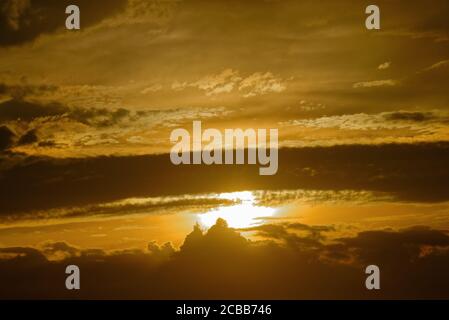 Abstract pattern of yellow brown clouds formed during a dramatic sunset Stock Photo