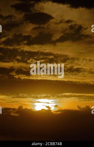 Abstract pattern of yellow brown clouds formed during a dramatic sunset Stock Photo