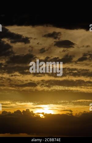 Abstract pattern of yellow brown clouds formed during a dramatic sunset Stock Photo