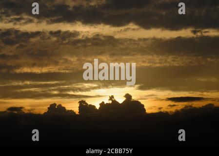 Abstract pattern of yellow brown clouds formed during a dramatic sunset Stock Photo