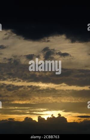 Abstract pattern of yellow brown clouds formed during a dramatic sunset Stock Photo
