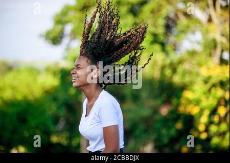 Young african girl playing and dancing  in the nature
