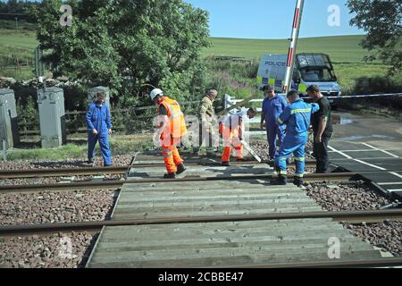 Emergency personnel at Carmont crossing, where they are removing wooden supports, so that emergency vehicles can access the train line from the road, south of the scene in Stonehaven, Aberdeenshire, where the 06.38 Aberdeen to Stonehaven ScotRail train derailed at about 9.40am this morning. The fire service, police and ambulance service are in attendance and the incident is ongoing. Stock Photo