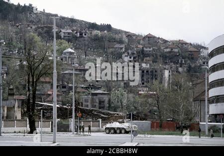 12th April 1994 During the Siege of Sarajevo: during a ceasefire, Ukrainian soldiers stand next to their APC near the front line, next to the Assembly Building. Stock Photo