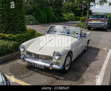 Classic MG sports car , with the top down, in a car park, UK Stock Photo