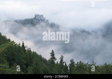 Slovakia - Ruin of castle Strecno. Beautiful autumn scenery of foggy valley in morning before sunrise. Europe. Beauty of nature concept background. Stock Photo