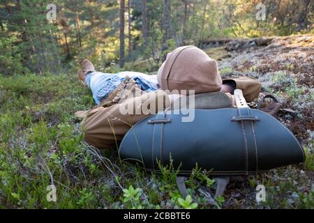Man lies on the grass, resting at the forest relaxing Stock Photo