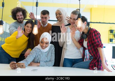 Group of young multiethnic Business people doing selfie after their work on new project. Stock Photo