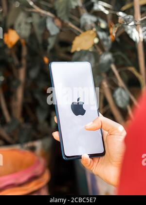 Assam, india - Augest 9, 2020 : Apple logo on phone screen stock image. Stock Photo