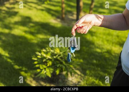 Close up view of female hand holding bunch of usual and electronic keys. Stock Photo