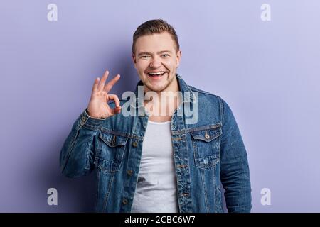 positive funny excired brutal man expressing his agreement, well done, body language, close up portrait Stock Photo