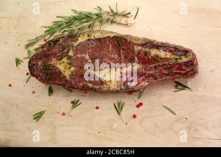 Raw Cote de boeuf seasoned with garlic butter. Stock Photo