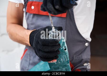 Man worker using hammer drill, close up Stock Photo