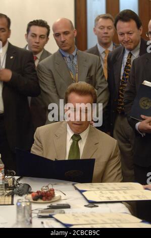 Austin, Texas USA, August 25, 2006: Flanked by his staff, California Governor Arnold Schwarzenegger speaks at a negotiating session at the Border Governors conference at the Texas Capitol. The annual meeting gives the six Mexican and four U.S. border governors a chance to discuss mutual issues of immigration, economics and border security issues. ©Bob Daemmrich Stock Photo