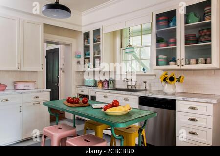 A beautiful kitchen with dark wood cabinets, marble countertops, chairs  sitting at the island, and stainless steel appliances. No brands or names  Stock Photo - Alamy