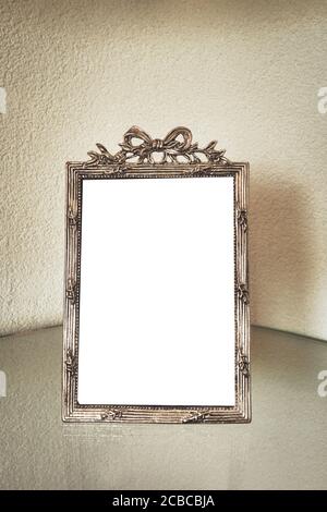 Antique silver photo frame on the table, blank with isolated white background for text. beautiful vintage decoration Stock Photo
