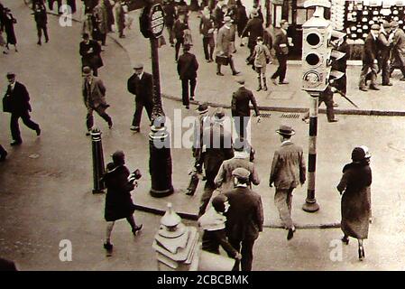 1930's experimental traffic lights (red and green) for pedestrian crossings. Road studs and Belisha Beacon systems (an amber-coloured globe lamp  on top of  tall black and white pole), followed in 1934. Stock Photo