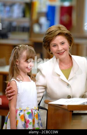 Austin, Texas USA, August 14, 2007: First Lady Laura Bush, wife of U.S. President George W. Bush, speaks at the Westbank Library in suburban Westlake Hills where a new branch library will be named for her next year. This will be the first library in the U.S. named in honor of Mrs. Bush, a former Texas public school librarian. Mrs. Bush signs the first book in the new library for five-year-old Reese Phinney.   ©Bob Daemmrich Stock Photo