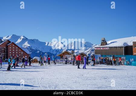 L'Alpe D'Huez , France 30.12.2019 Amazing winter landscape with snow covered mountain peaks. Winter sports. Alpine village surrounded by high mountains in winter. Ski resort in the french alps.  Stock Photo