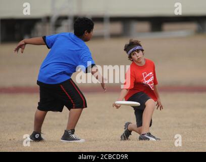 Austin, Texas, USA, December 13, 2008: Sixth and seventh grade middle school children compete in an Ultimate disc tournament where five-member co-ed school teams compete against one another. The sport of Ultimate emphasizes aerobic, spirited competition along with fair play and sportsmanship.     ©Bob Daemmrich Stock Photo