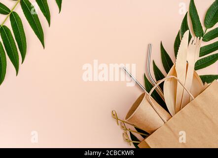 Plastic free set with bamboo, paper cutlery and metal straws on pink background. Zero waste concept. Stock Photo