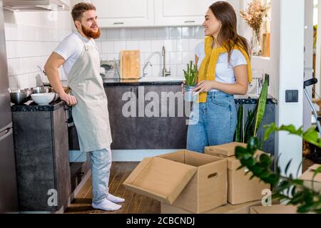 happy lovely caucasian couple moving into new apartment, do repairs, they unpack boxes together, couple works as a team. family, apartment, house, mov Stock Photo
