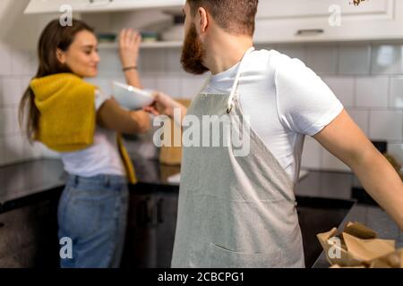 young caucasian married couple are moving to another apartment, they happily unpack boxes together. happy family, house concept Stock Photo