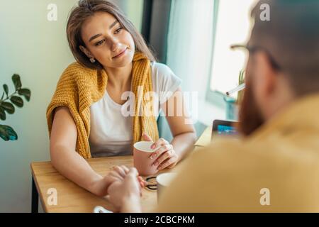 cute caucasian wife look at working husband with love, married couple at home. man sit using laptop, at freelance Stock Photo